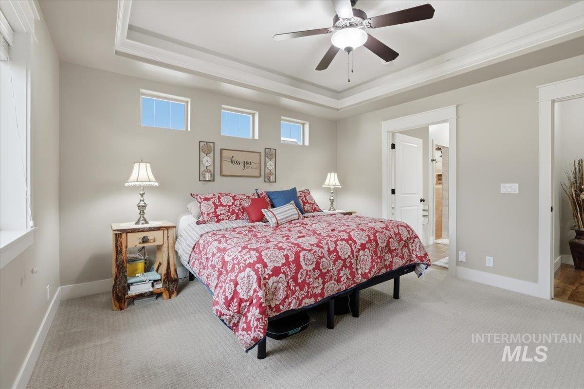 4604 Middlesboro Way Caldwell, ID 83607 - Photo 18 of 43 Carpeted bedroom with a raised ceiling and a ceiling fan