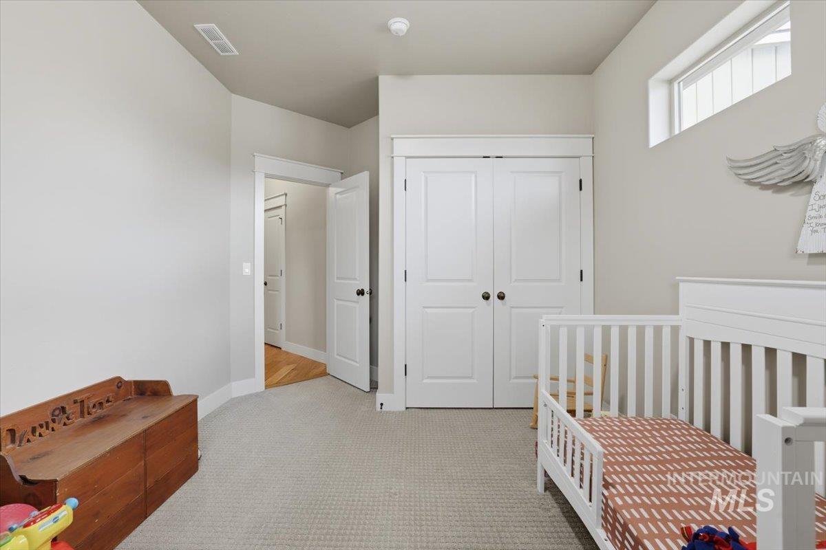 4604 Middlesboro Way Caldwell, ID 83607 - Photo 26 of 43 Bedroom with a nursery area, light carpet, and a closet