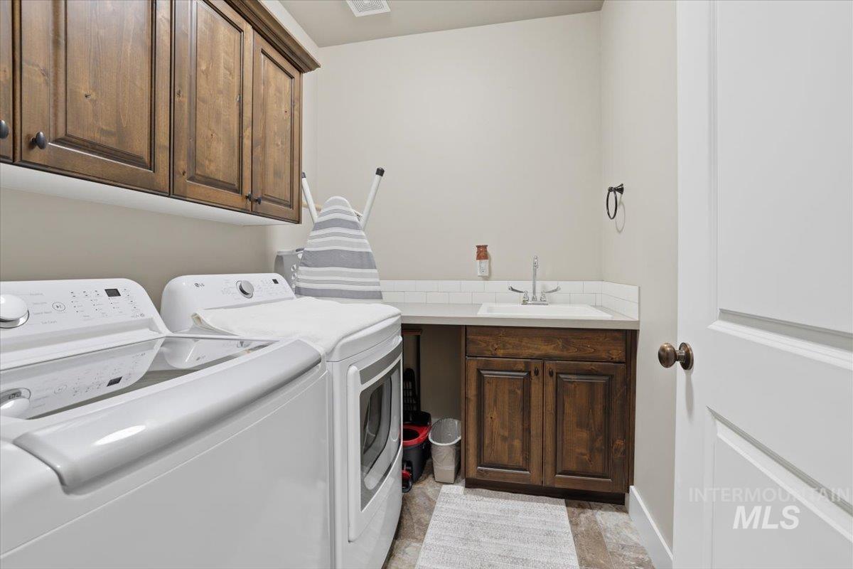 4604 Middlesboro Way Caldwell, ID 83607 - Photo 29 of 43 Laundry room featuring cabinet space and washing machine and clothes dryer