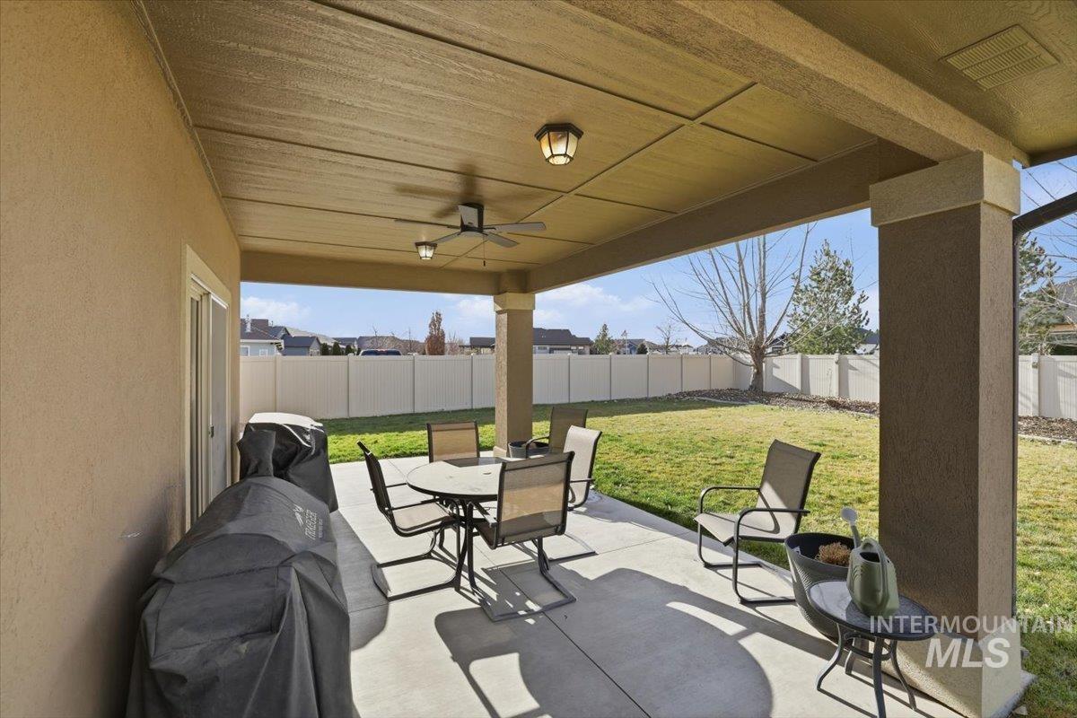 4604 Middlesboro Way Caldwell, ID 83607 - Photo 30 of 43 Fenced backyard featuring outdoor dining space, a patio area, a ceiling fan, and a grill