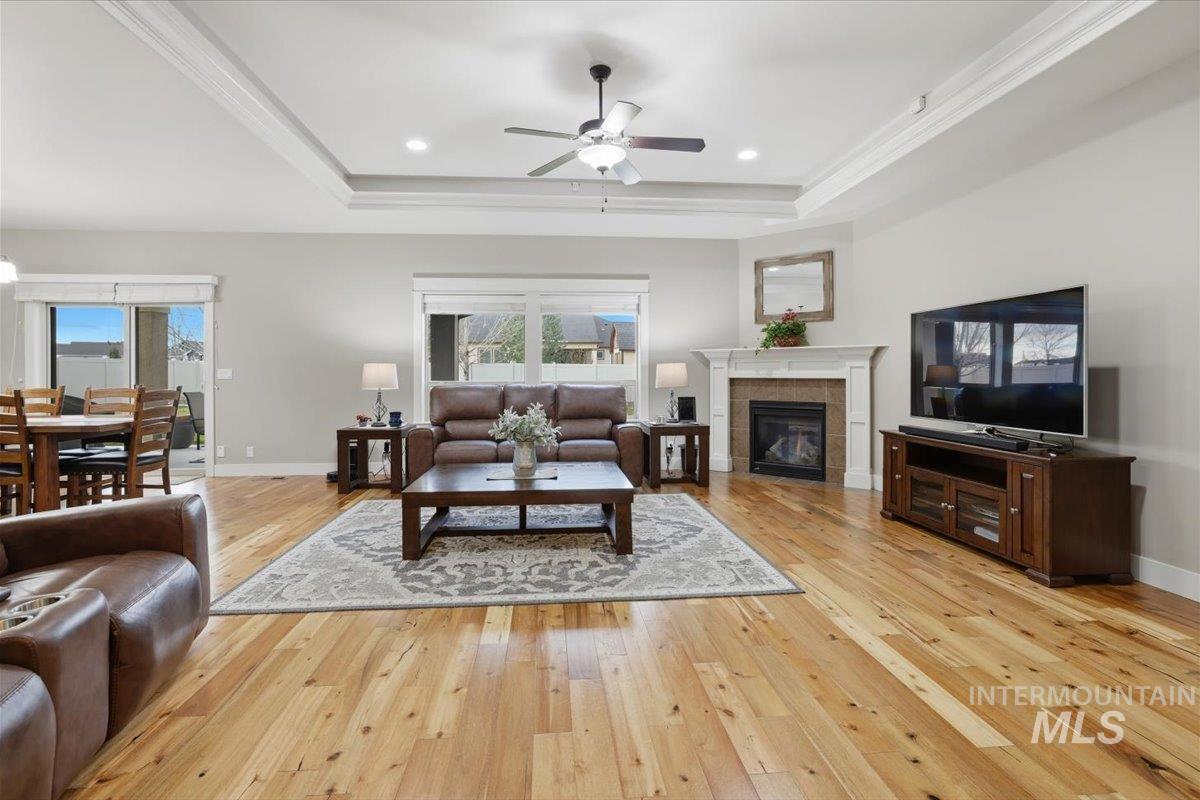 4604 Middlesboro Way Caldwell, ID 83607 - Photo 6 of 43 Living room featuring a fireplace, light wood-style flooring, ceiling fan, recessed lighting, and ornamental molding