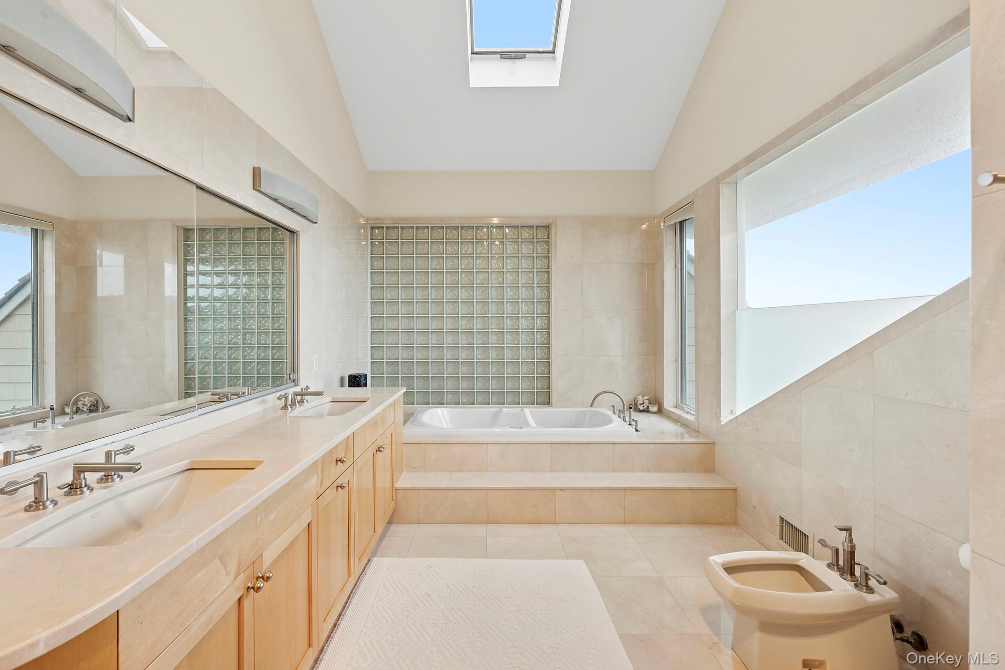 63-65 Dune Road Quogue, NY 11959 - Photo 11 of 29 a spacious bathroom with sink shower and bathtub