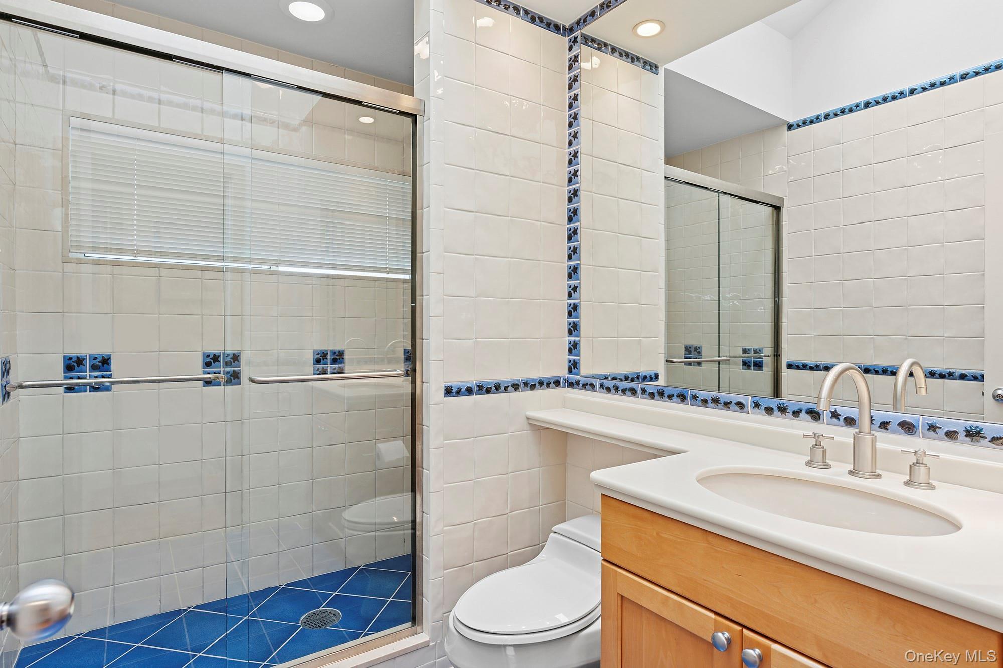 63-65 Dune Road Quogue, NY 11959 - Photo 15 of 29 a bathroom with a sink a toilet and shower