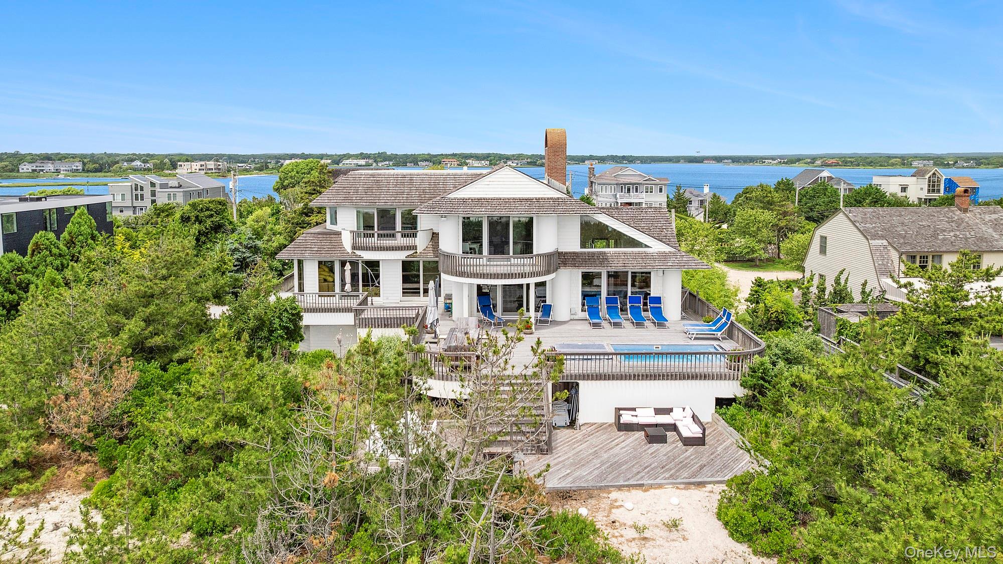 63-65 Dune Road Quogue, NY 11959 - Photo 21 of 29 an aerial view of a house with a garden