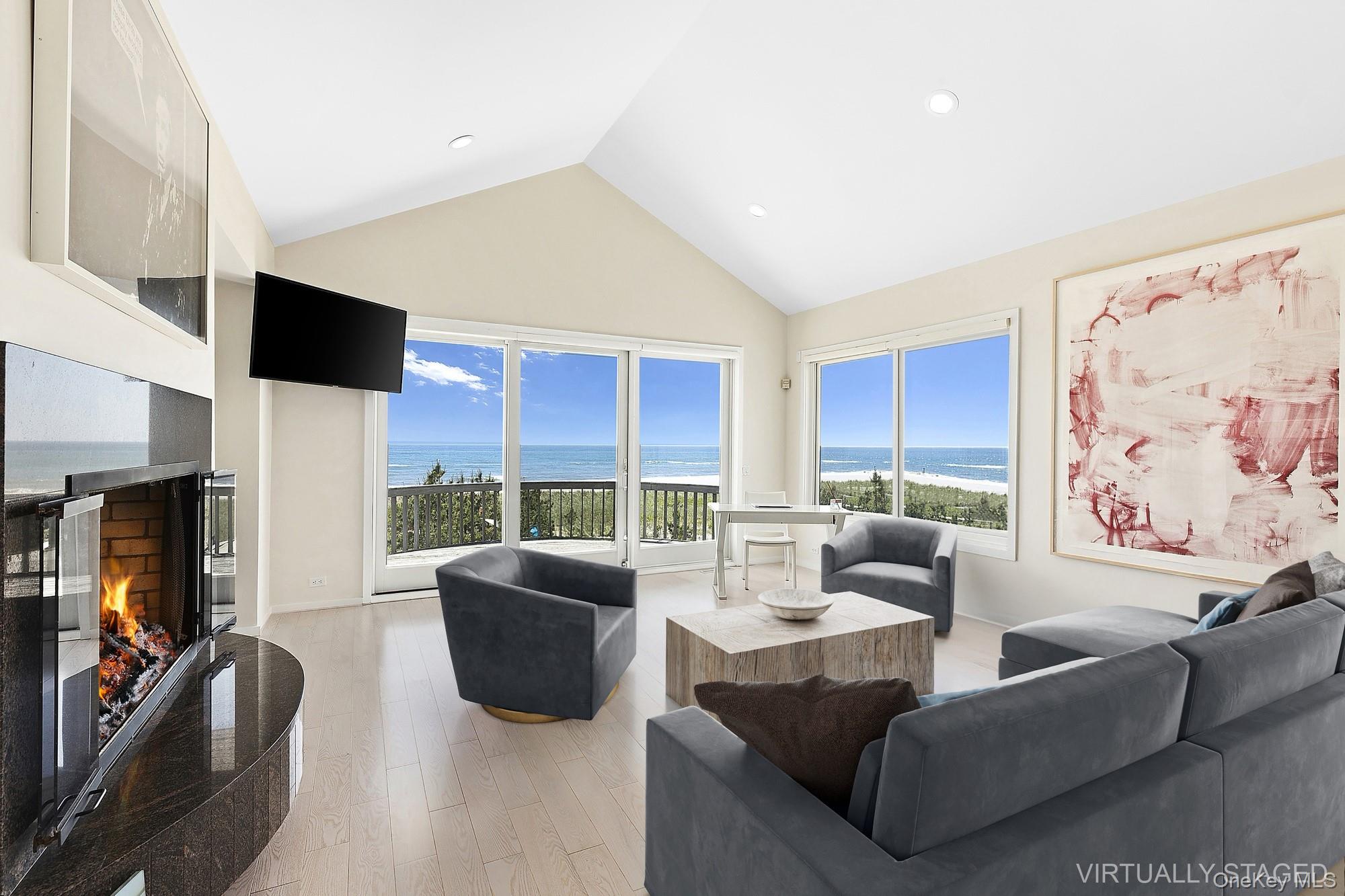 63-65 Dune Road Quogue, NY 11959 - Photo 5 of 29 a living room with furniture and a flat screen tv