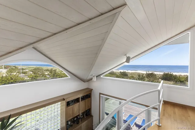 a bedroom with two large bed and a large window