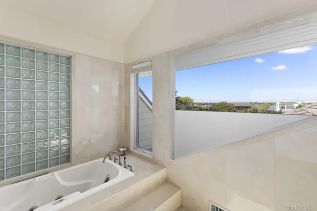 a spacious bathroom with sink shower and bathtub