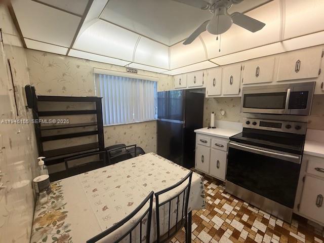 8818 West McNab Road, Unit 206 Tamarac, FL 33321 - Photo 3 of 9 a kitchen that has a stove and a refrigerator