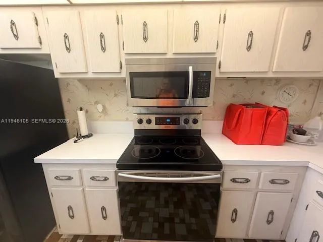 a white stove top oven sitting inside of a kitchen