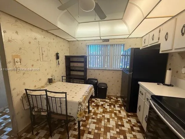 a kitchen with a sink a refrigerator and a stove