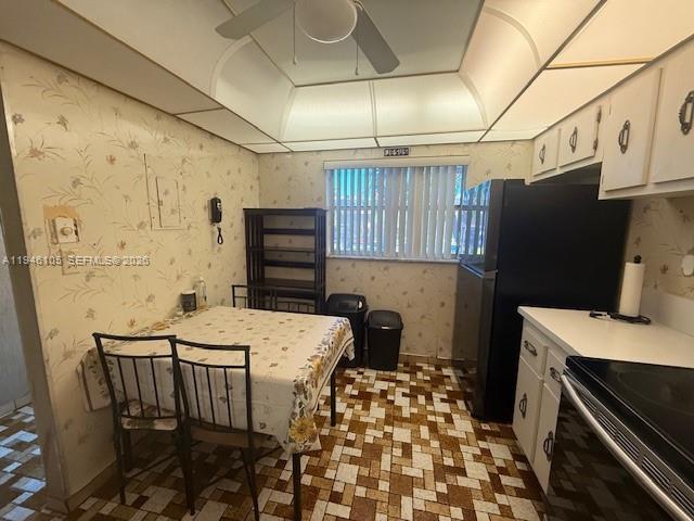 8818 West McNab Road, Unit 206 Tamarac, FL 33321 - Photo 7 of 9 a kitchen with a sink a refrigerator and a stove