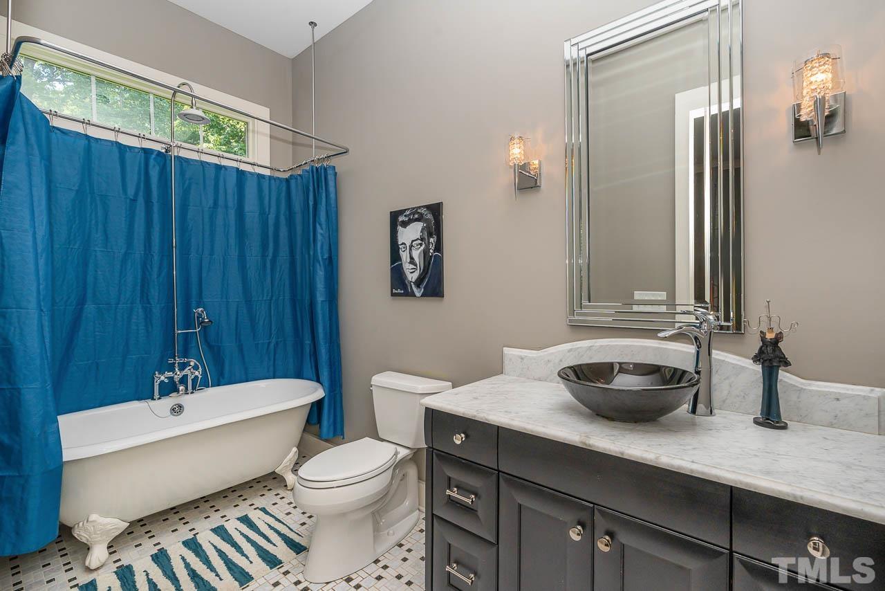 8615 Oneal Road Raleigh, NC 27613 - Photo 13 of 58 a bathroom with a toilet a sink and bathtub