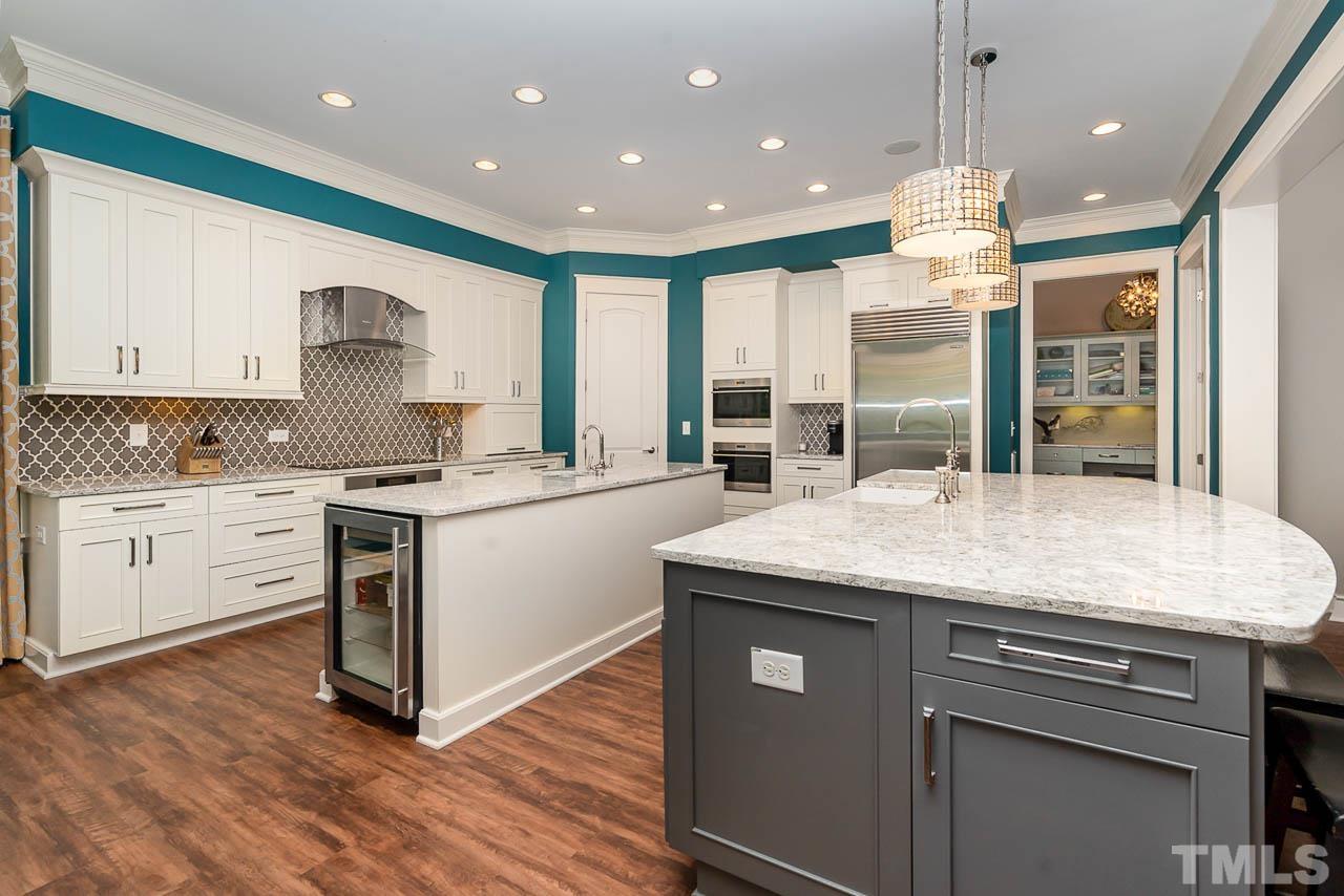 8615 Oneal Road Raleigh, NC 27613 - Photo 26 of 58 a kitchen with stainless steel appliances granite countertop wooden cabinets and a granite counter tops