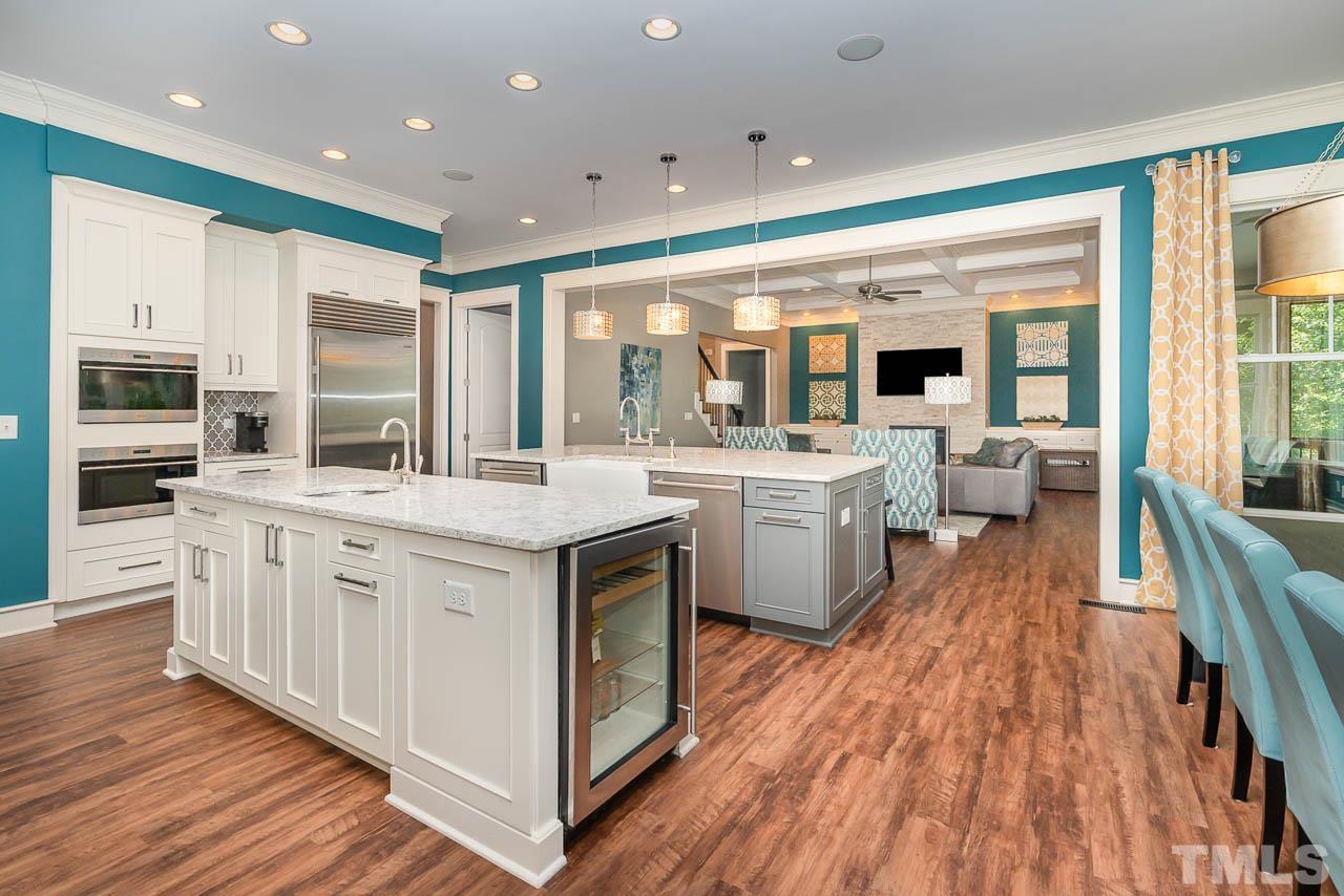 8615 Oneal Road Raleigh, NC 27613 - Photo 27 of 58 a large white kitchen with a large window a sink and stainless steel appliances