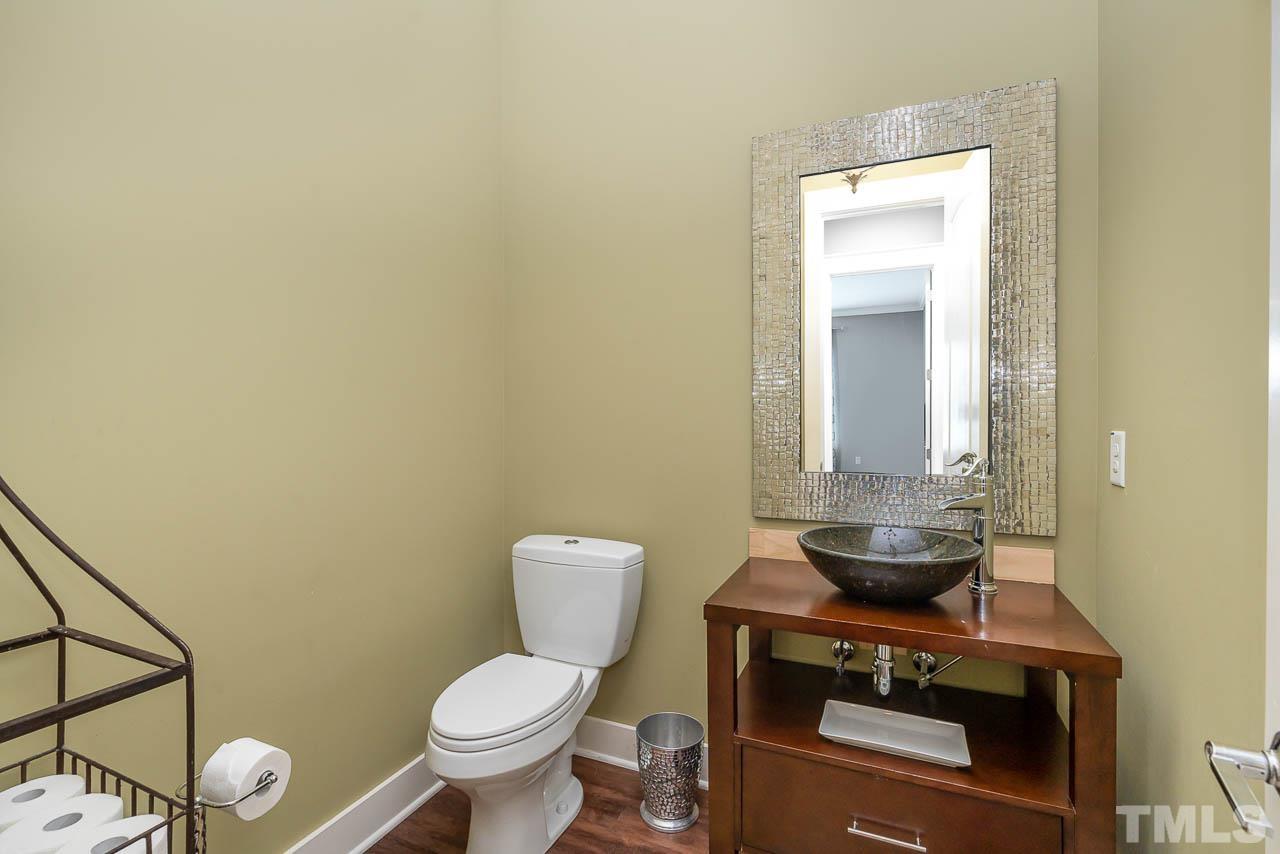 8615 Oneal Road Raleigh, NC 27613 - Photo 10 of 58 a white toilet sitting next to a bathroom sink