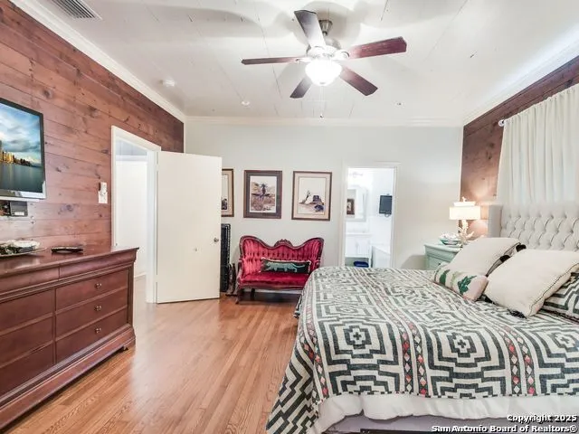 a bedroom with a large bed and a flat screen tv