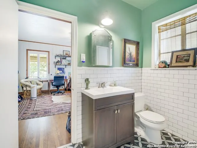 a bathroom with a toilet sink and mirror
