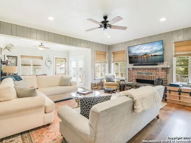 a living room with fireplace furniture and a flat screen tv