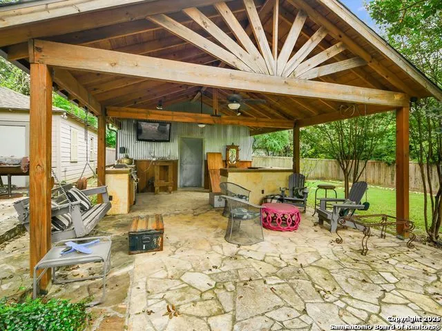 a patio with glass top table and chairs