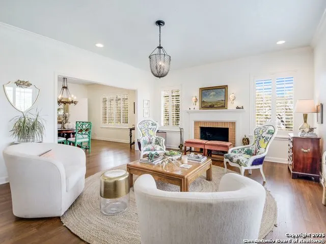 a living room with furniture a fireplace and a large mirror