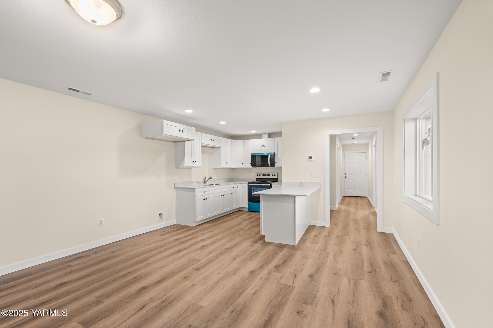 a view of a kitchen with wooden floor