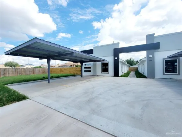 a view of a house with backyard and a garage