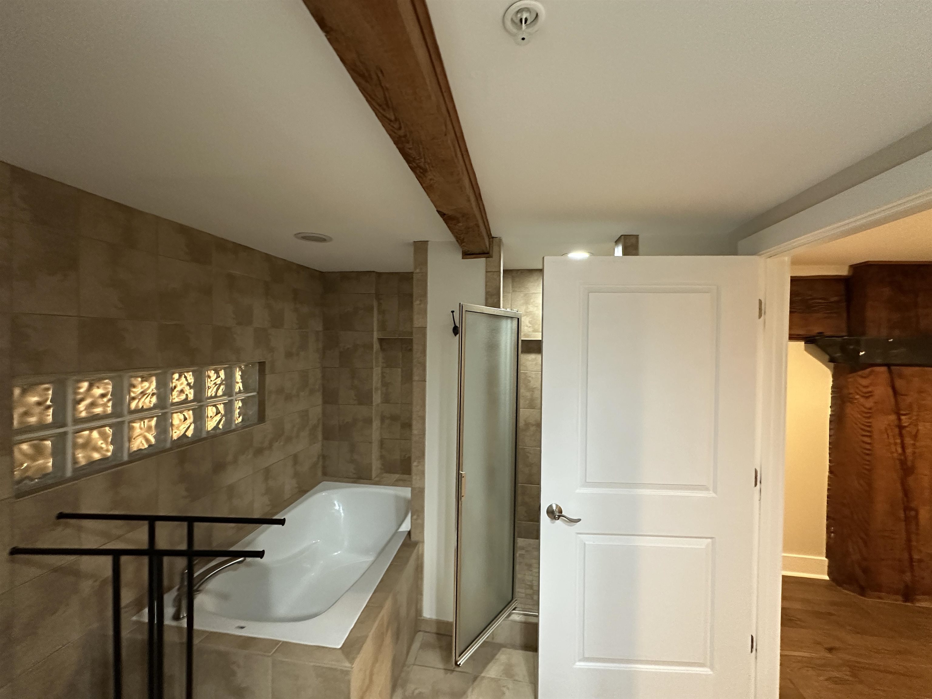 435 South Front Street, Unit 109 Memphis, TN 38103 - Photo 11 of 25 Full bathroom featuring a bath, a shower stall, and beam ceiling