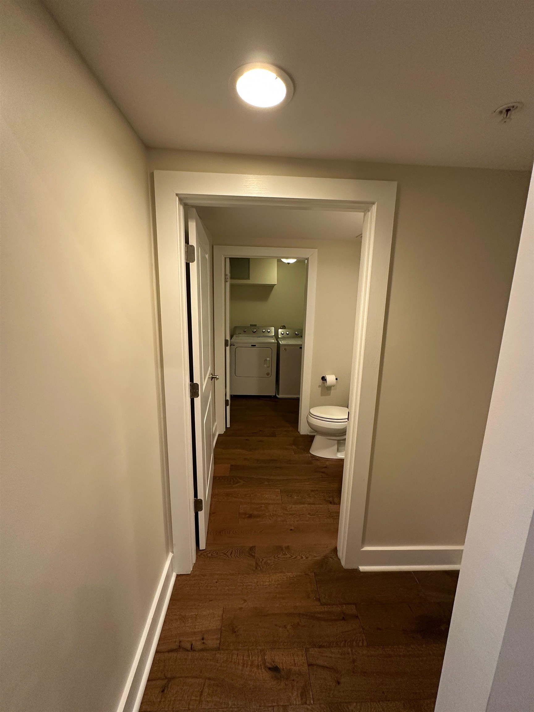435 South Front Street, Unit 109 Memphis, TN 38103 - Photo 17 of 25 Hall with washer and clothes dryer and dark wood finished floors