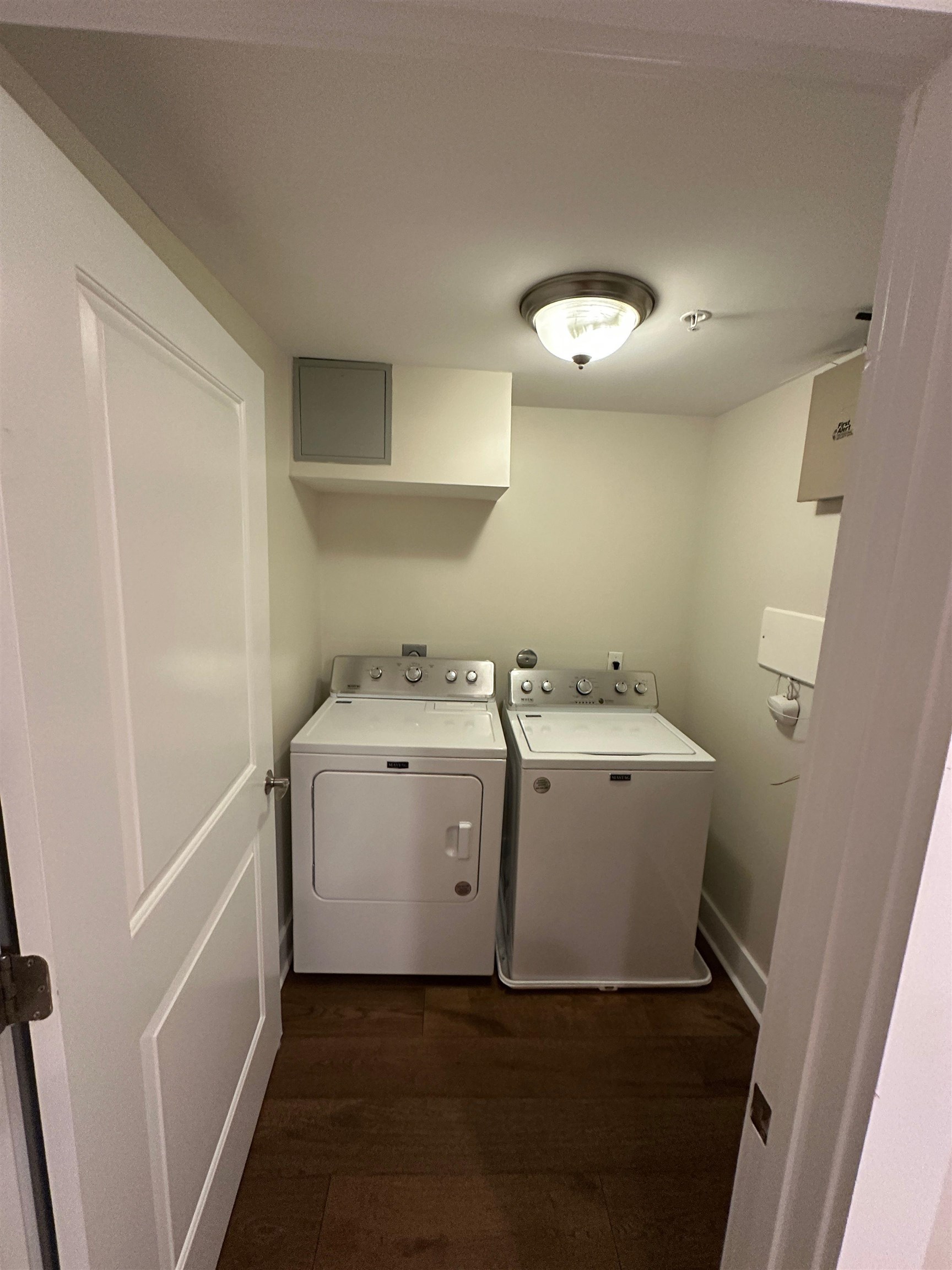 435 South Front Street, Unit 109 Memphis, TN 38103 - Photo 18 of 25 Laundry area with dark wood finished floors and washer and clothes dryer