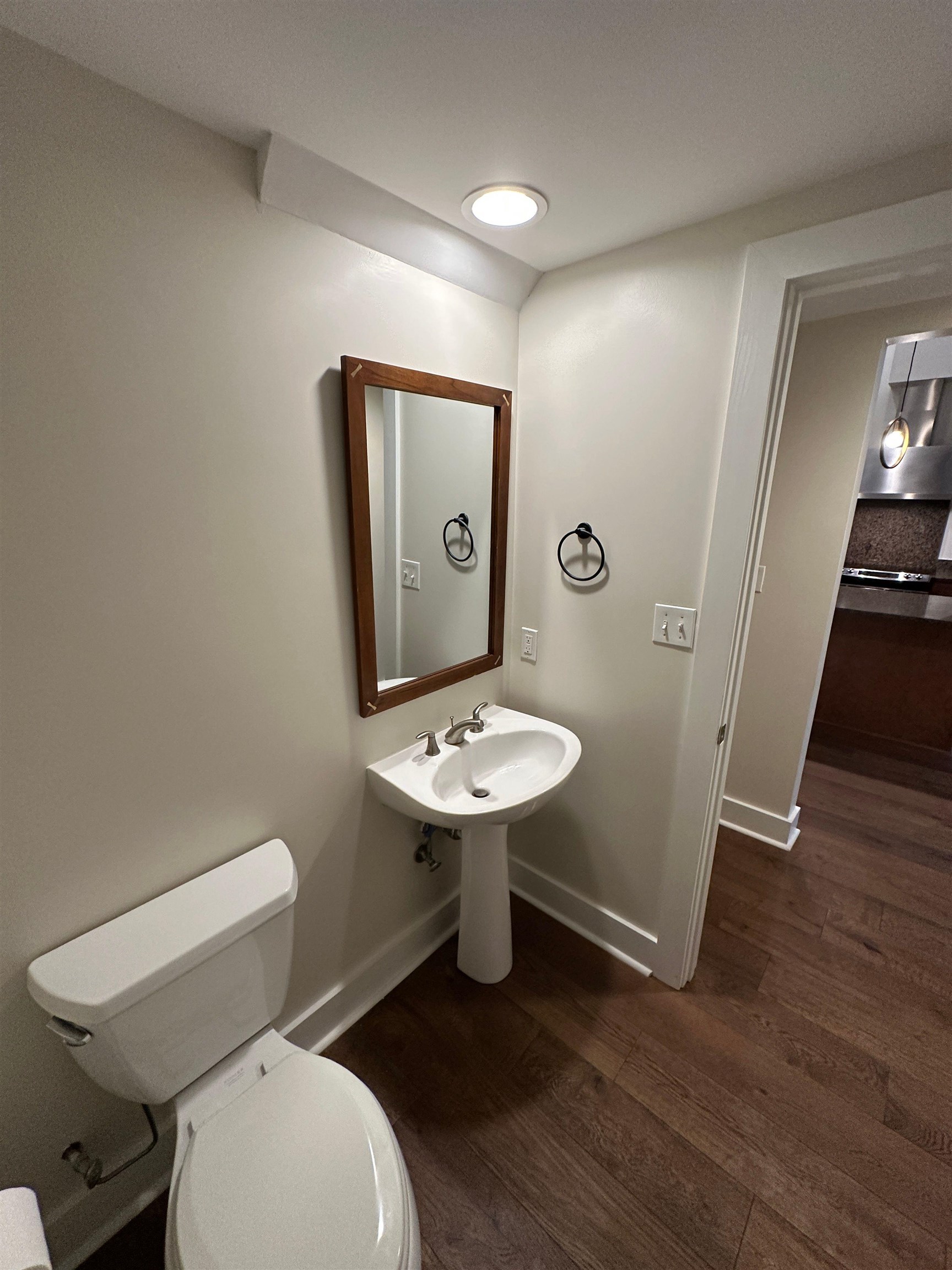 435 South Front Street, Unit 109 Memphis, TN 38103 - Photo 19 of 25 Half bathroom with toilet and dark wood-type flooring