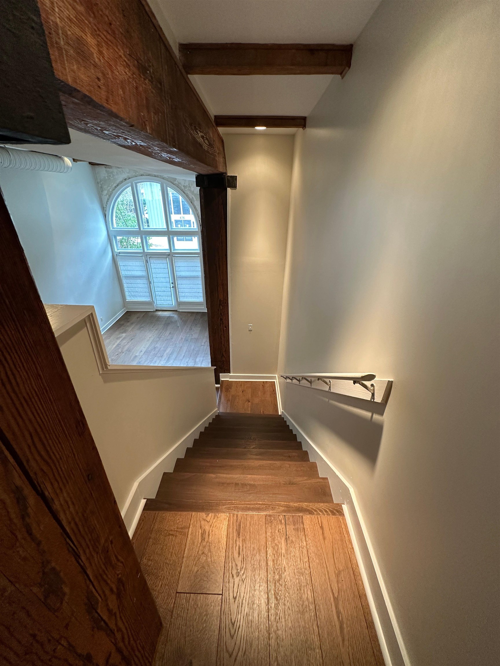 435 South Front Street, Unit 109 Memphis, TN 38103 - Photo 9 of 25 Stairs featuring beam ceiling, hardwood / wood-style flooring, and recessed lighting