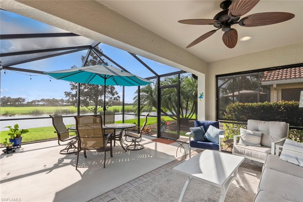 5796 Declaration Court Ave Maria, FL 34142 - Photo 24 of 49 a view of a patio with table and chairs under an umbrella