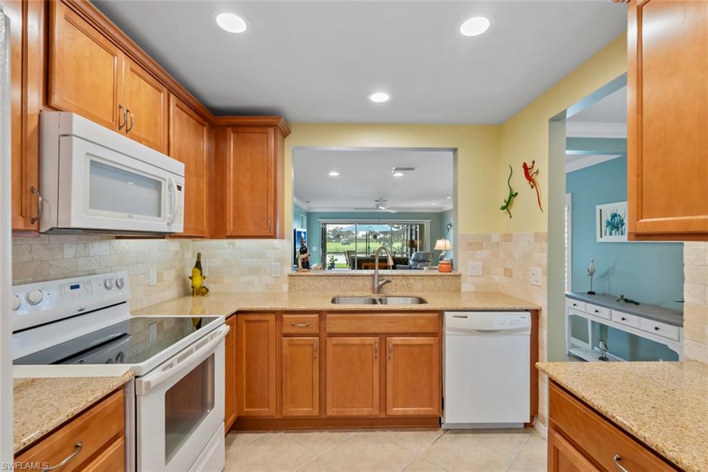 5796 Declaration Court Ave Maria, FL 34142 - Photo 5 of 49 a kitchen with a sink stove and cabinets