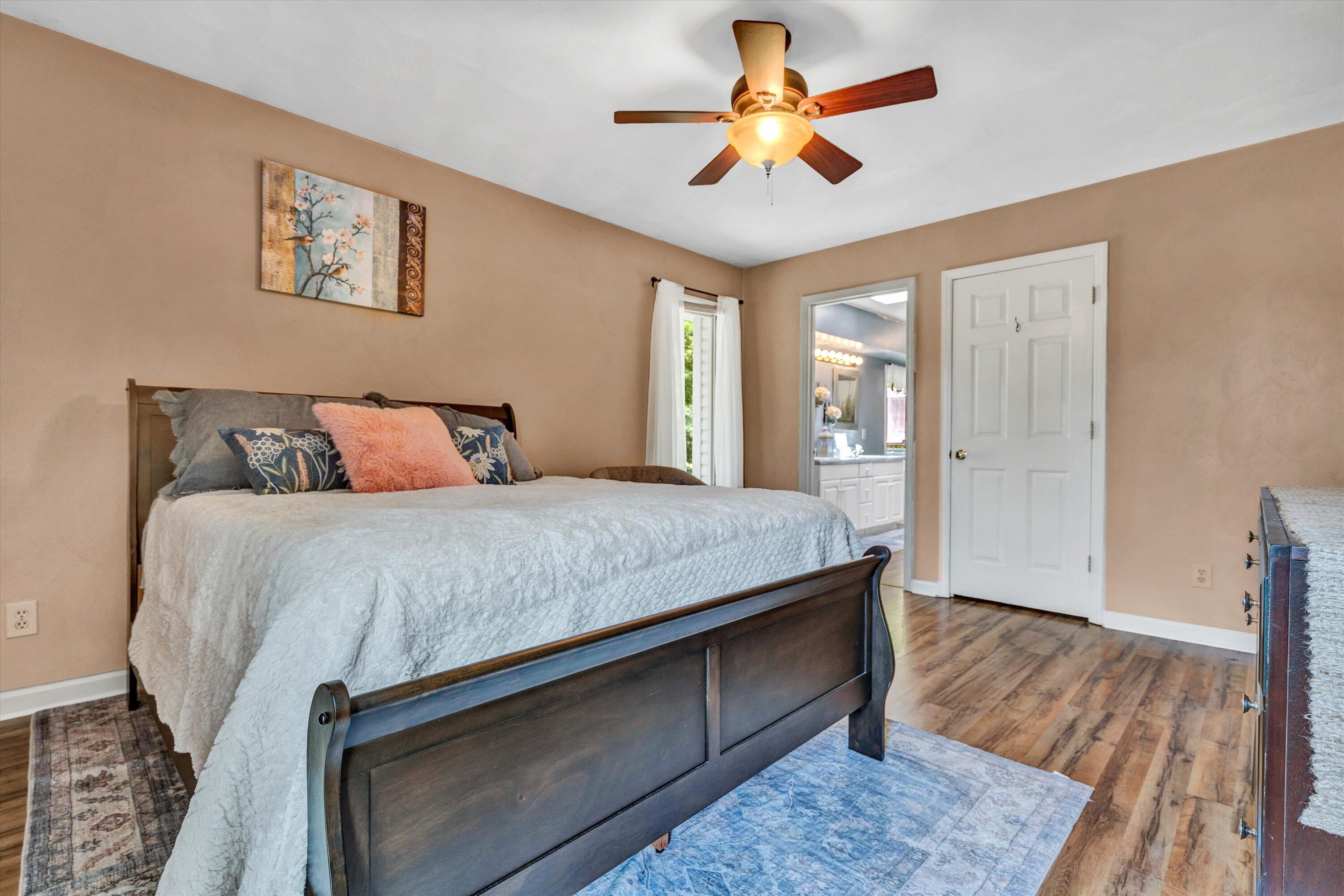 164 Deer Track Cloverdale, VA 24077 - Photo 13 of 28 a bedroom with a large bed and a chandelier