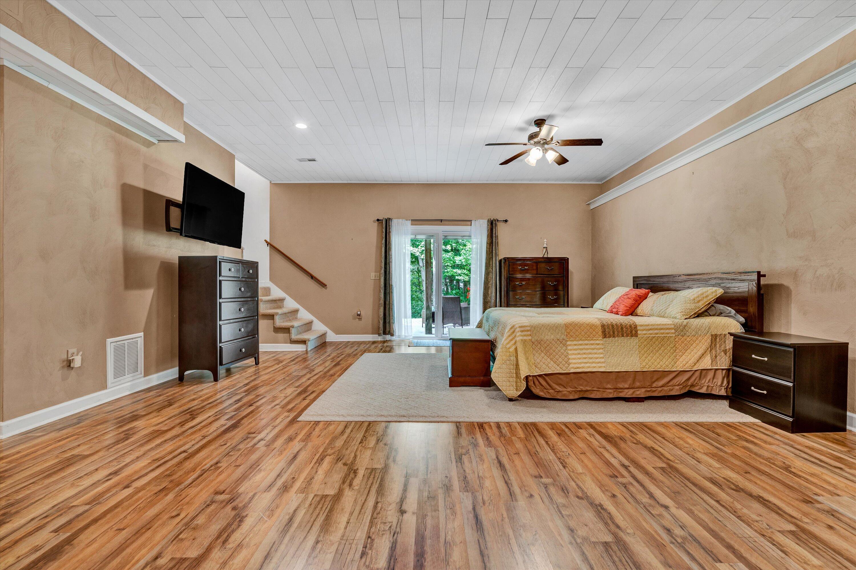 164 Deer Track Cloverdale, VA 24077 - Photo 21 of 28 a spacious bedroom with a bed and a flat screen tv