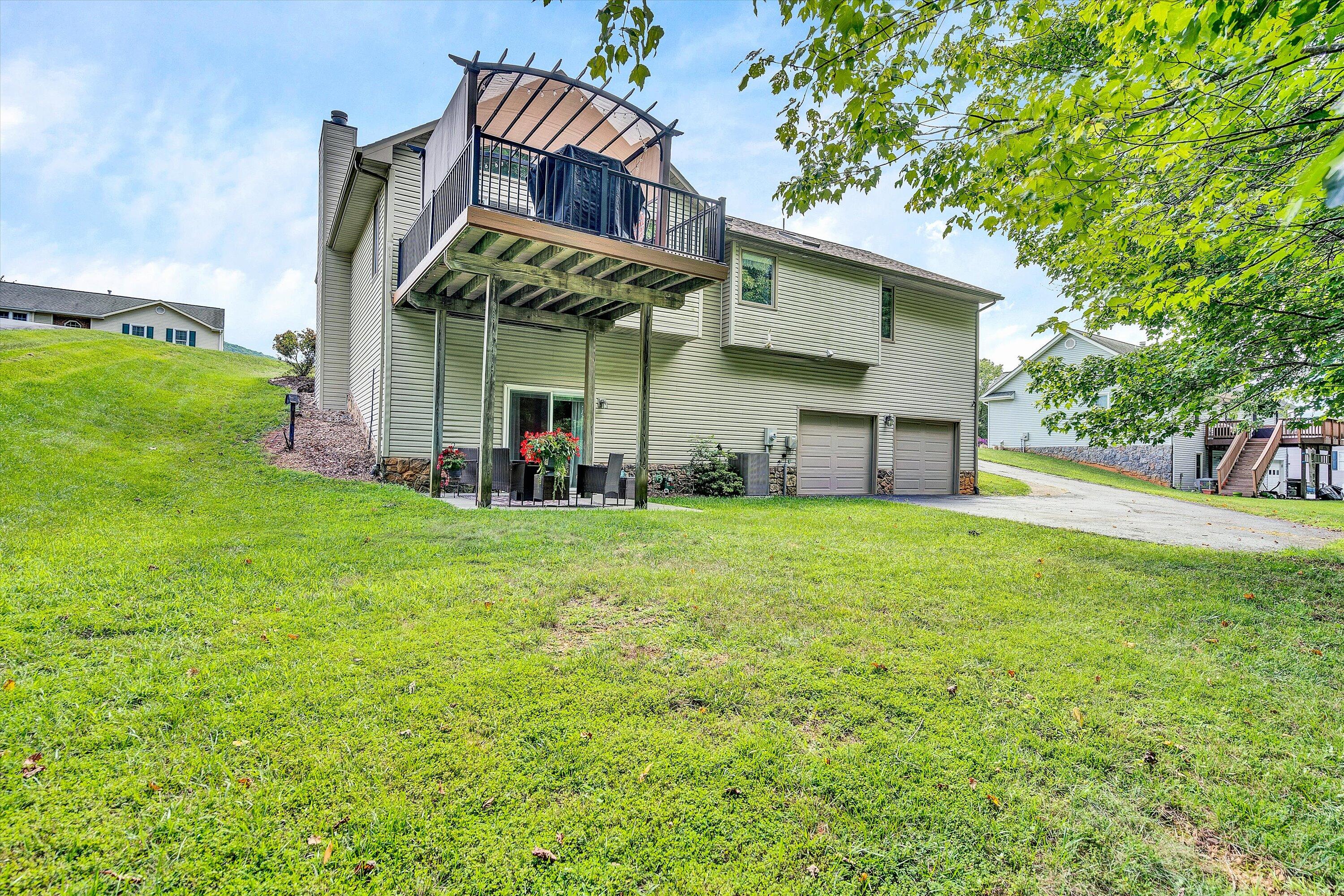164 Deer Track Cloverdale, VA 24077 - Photo 27 of 28 a view of a house with a yard and garage