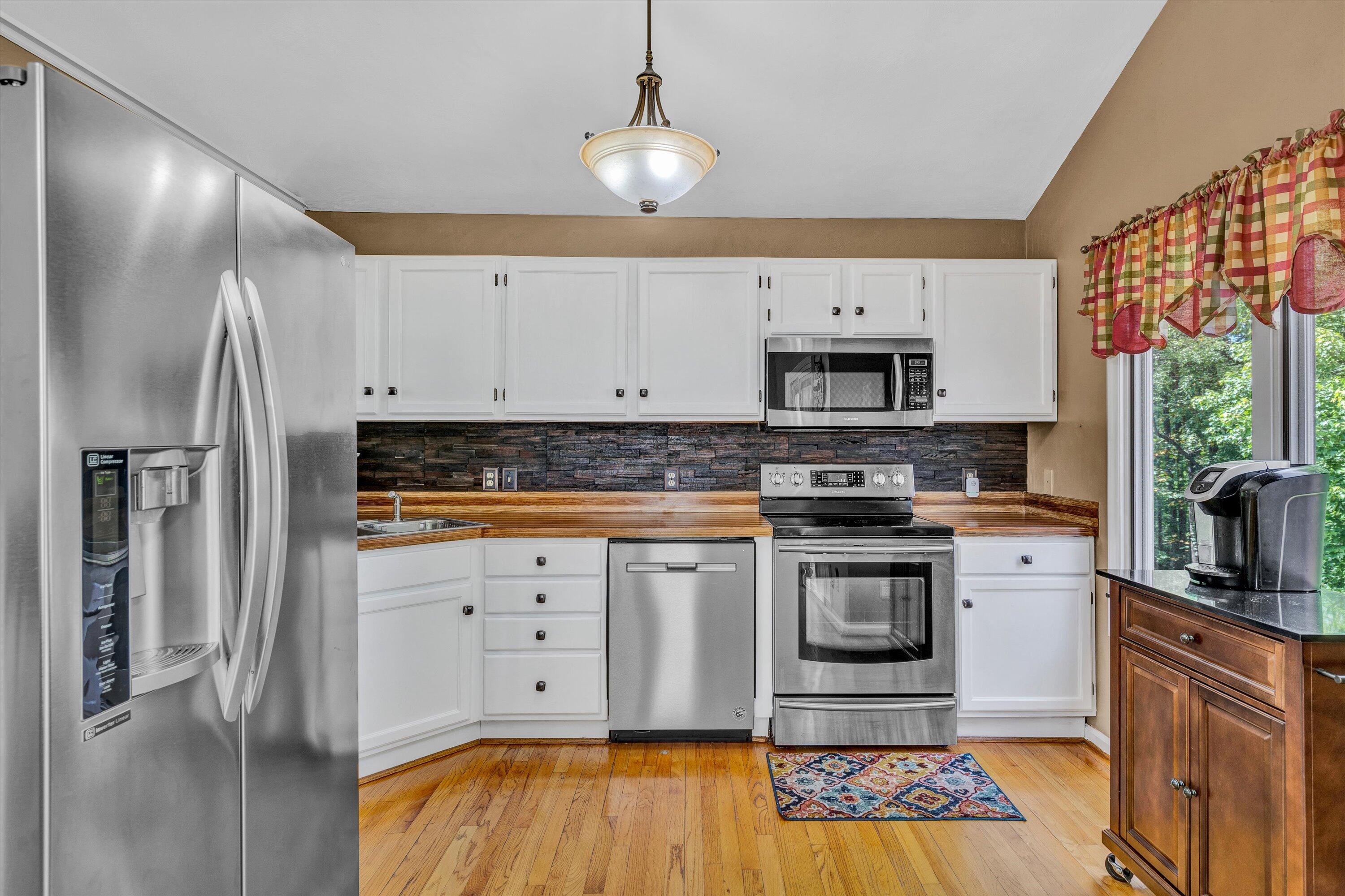 164 Deer Track Cloverdale, VA 24077 - Photo 7 of 28 a kitchen with stainless steel appliances a stove a sink and a refrigerator