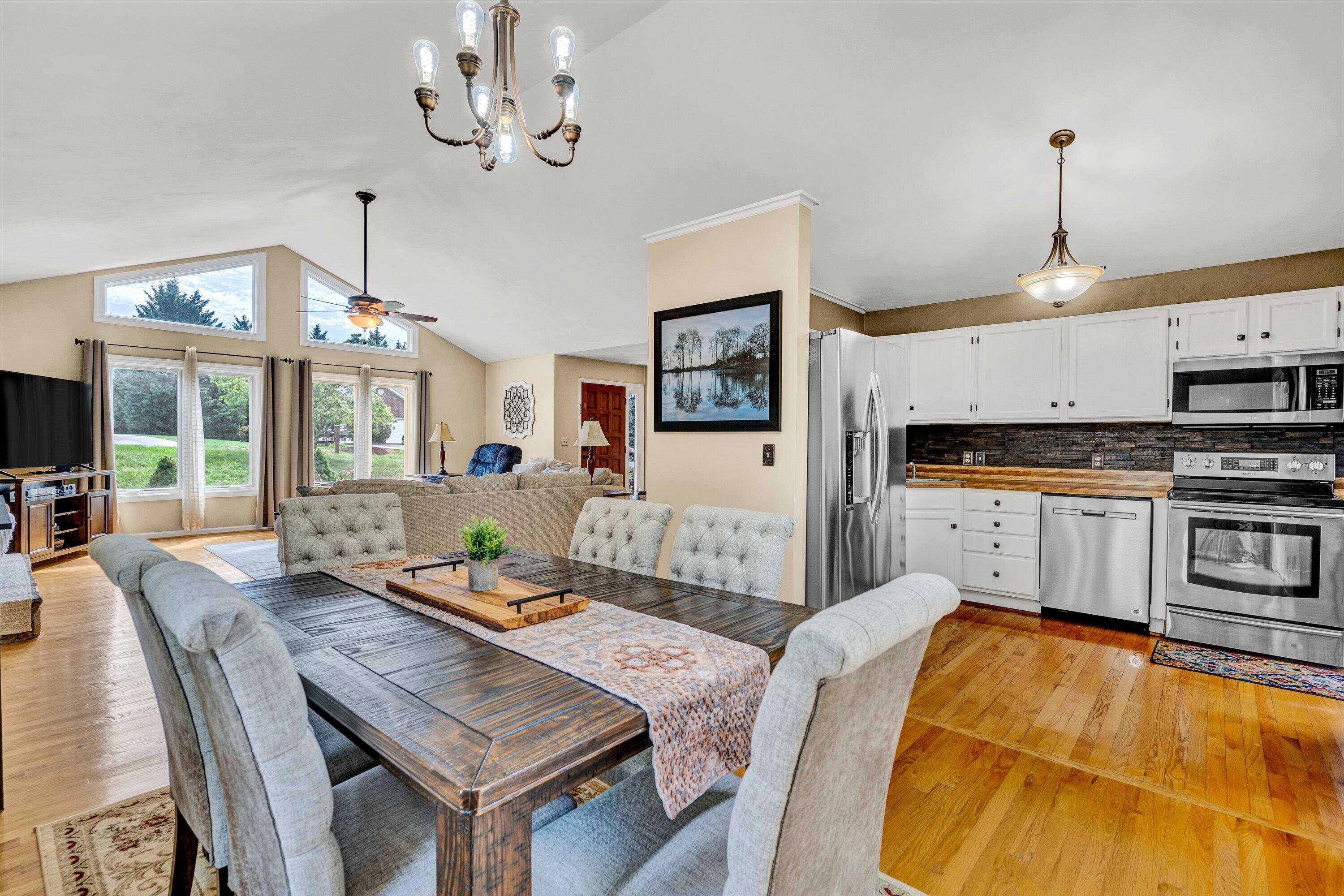 164 Deer Track Cloverdale, VA 24077 - Photo 9 of 28 a living room with kitchen island dining table and chairs