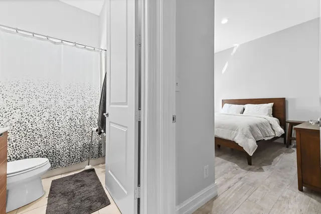 a bedroom with a bed and a rug