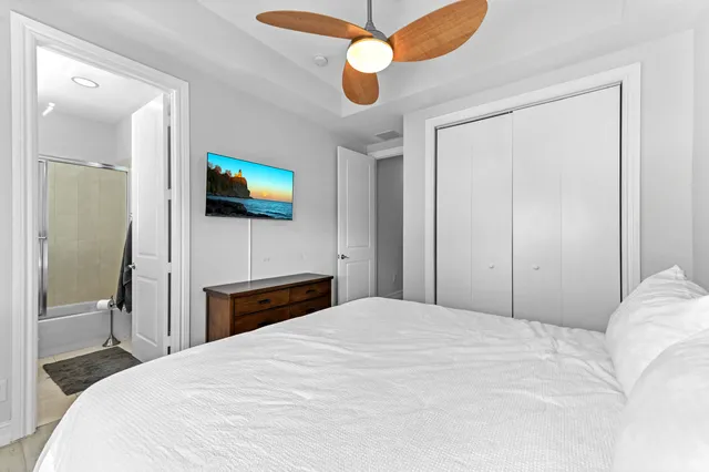 a bedroom with a bed and a flat screen tv