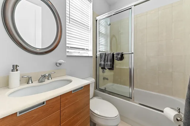 a bathroom with a sink a toilet and a mirror