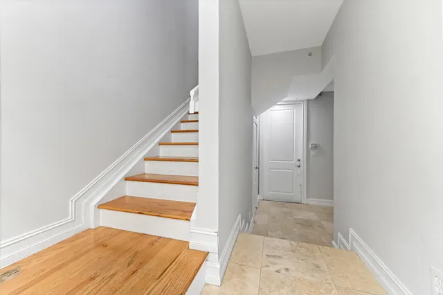 a view of entryway and hall with wooden floor