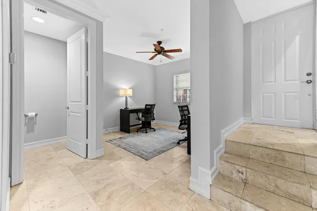 a view of a livingroom with furniture and a ceiling fan
