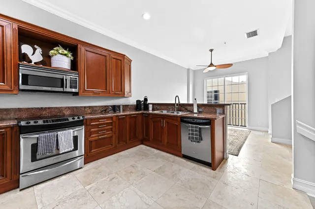 a kitchen with stainless steel appliances granite countertop a stove and a sink