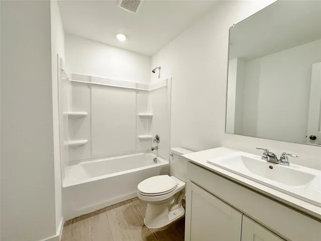 a bathroom with a sink a toilet and a bathtub