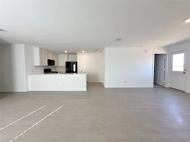 a view of a kitchen with a sink and white cabinets