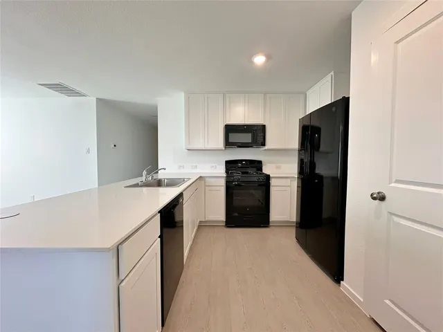 a kitchen with a refrigerator a sink and a stove