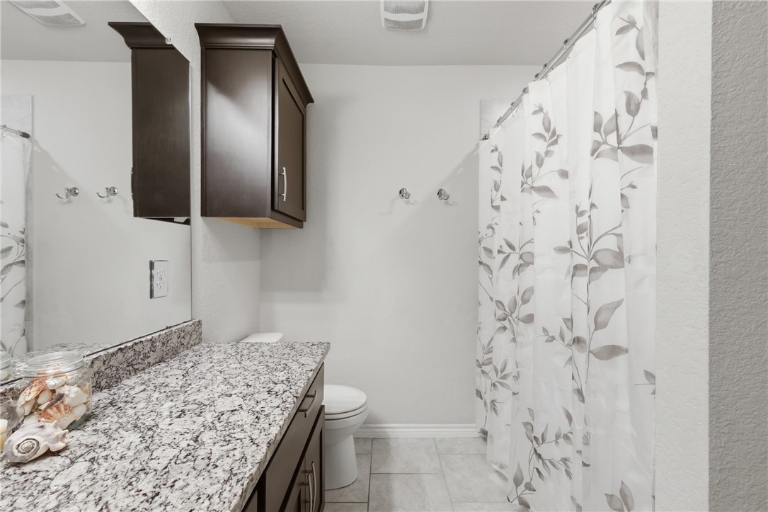 1943 Thorndyke Lane Bryan, TX 77807 - Photo 18 of 28 Upgraded cabinets and tile flooring, with tile surrounding the tub!