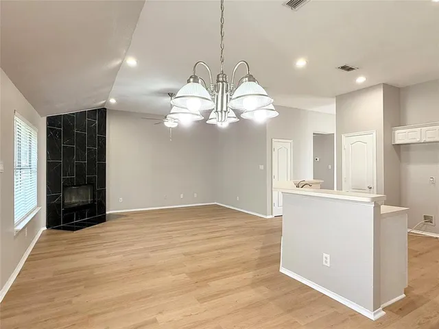 a view of kitchen with refrigerator microwave and stove