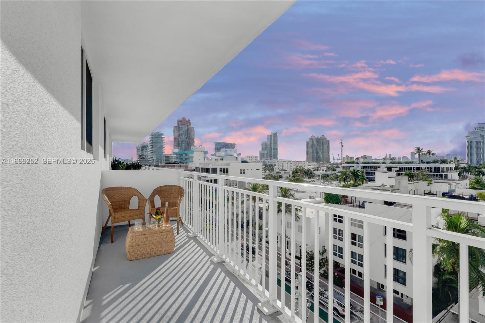 345 Ocean Drive, Unit 703 Miami Beach, FL 33139 - Photo 13 of 15 a view of roof deck with table and chairs and wooden floor